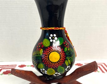 Vintage Mexican hand painted black clay vase vibrant floral designs and a decorative yarn tassel , folk art vase