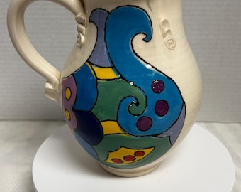Handmade artisan stoneware pottery pitcher , vibrant colors on white , signed Melanie Liotta