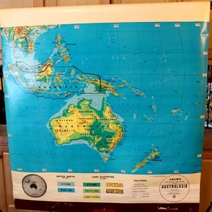 May include: A vintage map of Australasia, featuring a detailed depiction of the region's geography. The map includes land elevation and water depth indicators, with the title "CRAM'S AUSTRALASIA" at the bottom. The map is in shades of blue, green, and yellow.