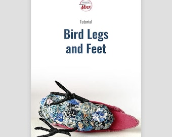 May include: A tutorial for making bird legs and feet. The image shows a close-up of a pair of black bird legs and feet attached to a pink fabric bird body with a floral pattern.