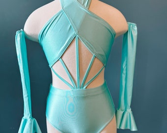 May include: A turquoise leotard with long sleeves and a criss-cross halter neckline. The leotard has a cut-out back with straps.