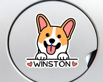 May include: A sticker featuring a cartoon corgi dog with orange, white, and pink coloring. The dog is smiling with its tongue out, and the name "WINSTON" is written below it with two heart symbols.