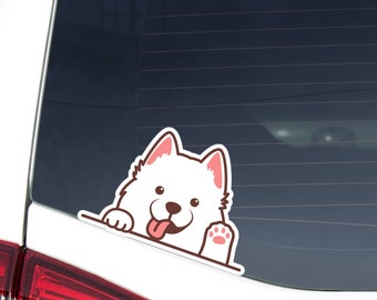 May include: A white dog sticker with pink accents, peeking over a surface. The cartoon dog has a happy expression, tongue out, and a paw visible. The sticker is likely for a car window or similar surface.