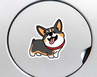 May include: A cartoon corgi dog sticker with a cheerful expression. The corgi has black, grey, and tan fur, a red collar, and a pink tongue. The sticker is on a silver surface.