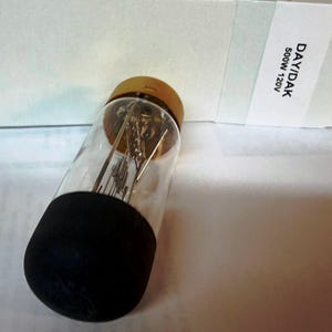 May include: A handmade, wooden cutting board with a natural finish. The board features a live edge on one side and a smooth, rectangular shape. It measures approximately 18 inches long and 12 inches wide.