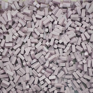 May include: A large pile of small, rectangular, light purple ceramic tiles.