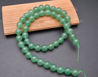 May include: A strand of light green jade beads, approximately 18 inches long, with a green thread.