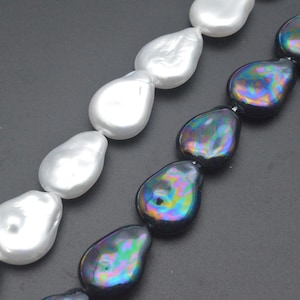 May include: Two strands of baroque pearls. One strand features large, lustrous white pearls. The other strand displays iridescent black pearls with a colorful, oil-slick sheen. The pearls are strung together, ready for jewelry making.