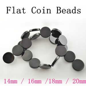 May include: A strand of black flat coin beads in various sizes, including 14mm, 16mm, 18mm, and 20mm. The beads are smooth and have a glossy finish.