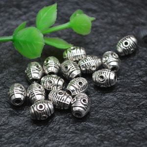 100 pièces de perles métalliques en forme de riz, couleur argent Antique 6x8mm, résultats de bijoux