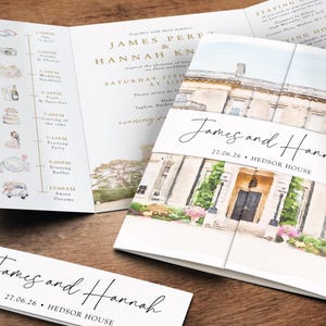 May include: Wedding invitation suite featuring a watercolor illustration of a stately home. The invitation includes the names "James and Hannah" and the date "27.06.26". Additional cards display the names and venue, along with the wedding schedule.