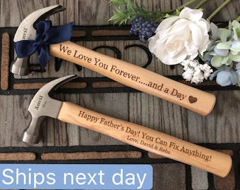 May include: Two steel claw hammers with light wood handles. The top hammer has a navy blue ribbon and is engraved with "We Love You Forever....and a Day" and a heart. The bottom hammer is engraved with "Happy Father's Day! You Can Fix Anything! Love, David & Reba".