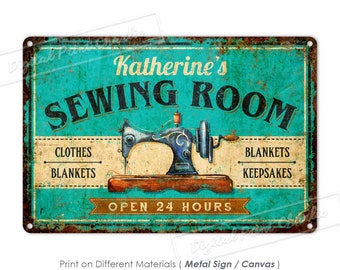 May include: A turquoise blue metal sign with a rusty border. The sign says "Katherine's Sewing Room" with a vintage sewing machine illustration. The sign also says "Open 24 Hours" and lists "Clothes, Blankets, Keepsakes".