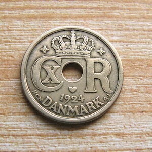 May include: A silver Danish coin featuring a crown, the letters "XOR", the year "1924", and the words "H.C.N. DANMARK G.J."