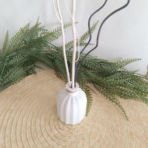 Small white perfume diffuser vase