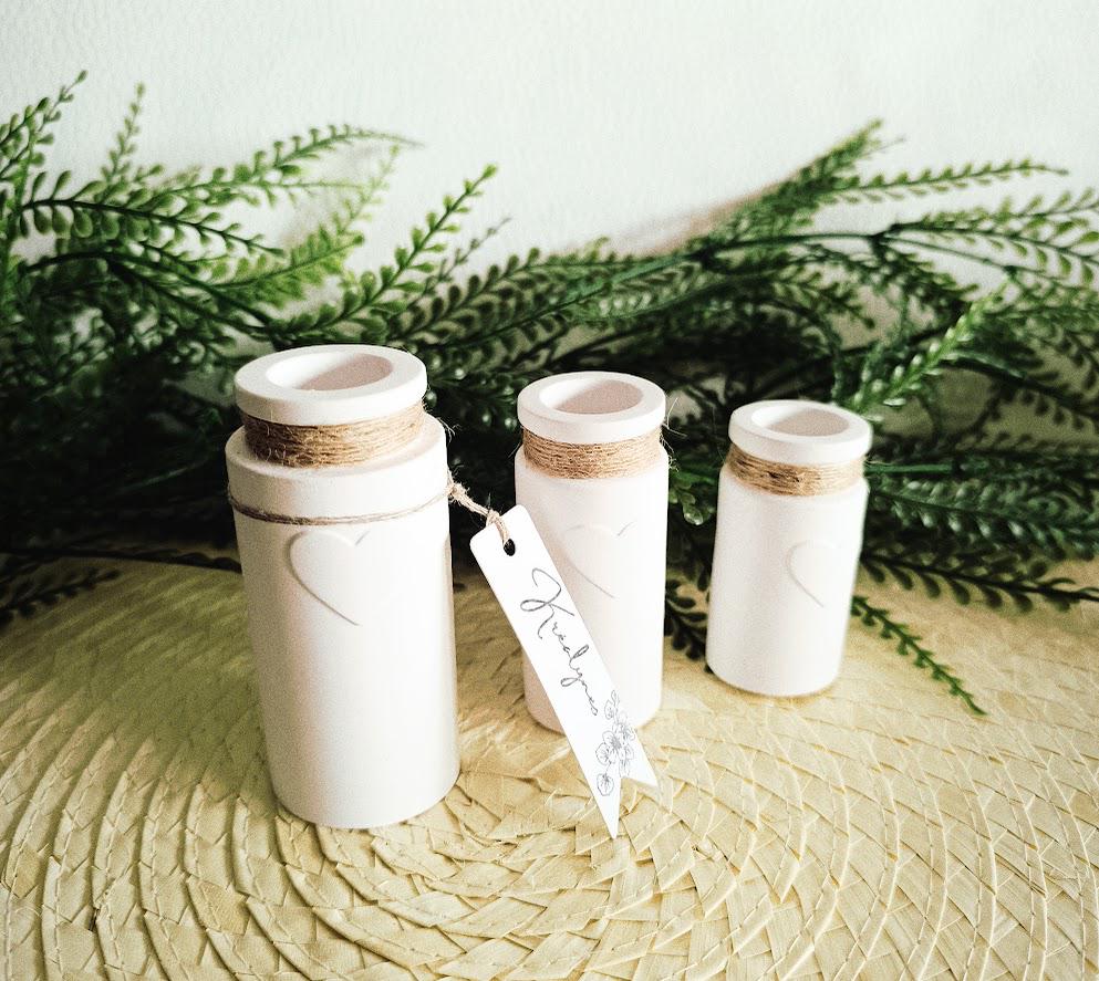 Three small white decorative vases
