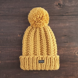 Yellow HoBo Handmade 'Lofty' Bobble Hat. Thick chunky hand knitted beanie with large removable pom pom. Wool blend. Available in 3 colours