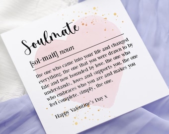 May include: A white card with a pink watercolor heart and gold glitter. The card defines the word "Soulmate" as "the one who came into your life and changed everything. The one that you were drawn to by fate and now bounded by love. The one who understands, loves and supports you. The one who embraces who you are and makes you feel complete. Simply, the one." The card also says "Happy Valentine's Day x".