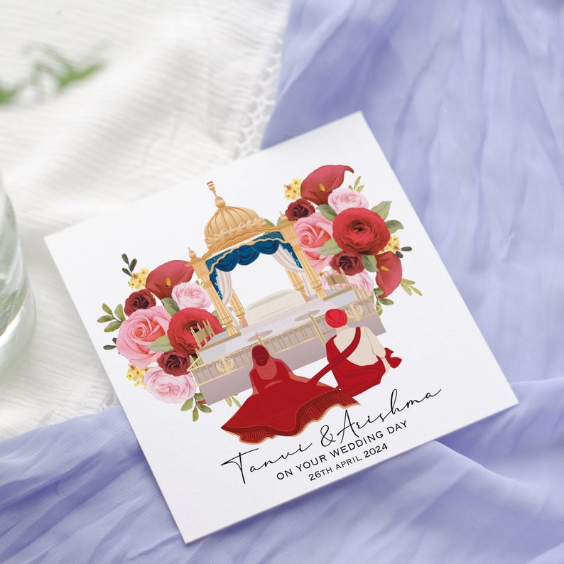 May include: A wedding invitation with a floral design featuring red and pink roses. The invitation reads "Tanvi & Aishma On Your Wedding Day 26th April 2024".