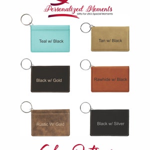 May include: Six different color options for a leather key chain card holder. The options are teal with black, tan with black, black with gold, rawhide with black, rustic with gold, and black with silver.