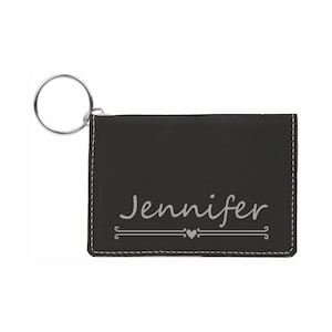 May include: Black leather key chain with a silver key ring and the name "Jennifer" engraved on the front.