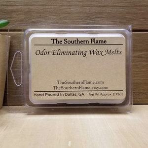 May include: A brown paper label with the text "The Southern Flame Odor Eliminating Wax Melts" and the website address "TheSouthernFlame.com" and "TheSouthernFlame.etsy.com". The label also states "Hand Poured In Dallas, GA Net Wt Approx. 2.75oz". The label is in a clear plastic container.