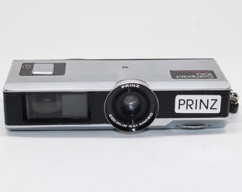 1970s Prinz Compact 100 - 110 Film Pocket Camera with new film and flash holder