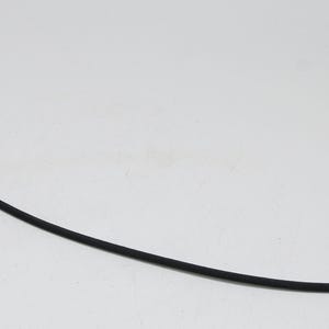 May include: A black camera shutter release cable with a silver-colored tip and connector. The cable is flexible and has a rubberized texture. The cable is used to remotely trigger a camera's shutter.
