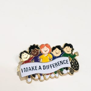 May include: A gold-colored pin with five cartoon children holding a banner that reads "I MAKE A DIFFERENCE". The children are of different races and have different colored hair and clothing. The child on the right is in a wheelchair.