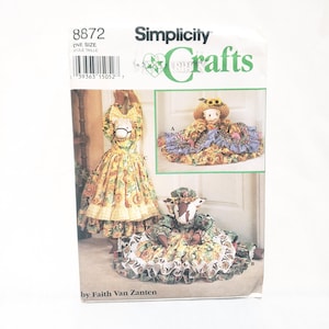 May include: Simplicity Crafts sewing pattern number 8872, one size, for making three doorstop dolls. The dolls are dressed in sunflower print dresses with ruffles. One doll has a horse head, one has a cow head, and one has a human head with a straw hat.