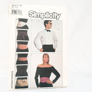 May include: A vintage Simplicity sewing pattern for waist cinchers. The pattern features illustrations of various styles, including a pink heart-patterned belt and a beige utility belt. The pattern includes the text "ONE SIZE" and "Simplicity".