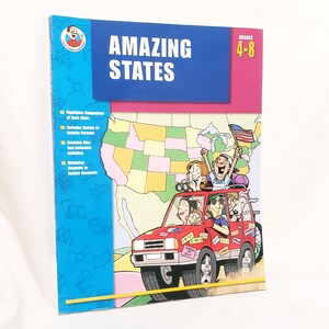 May include: A colorful educational book titled "AMAZING STATES" for grades 4-8. The cover features a red car filled with cartoon characters driving across a map of the United States. The book highlights the independence of each state.