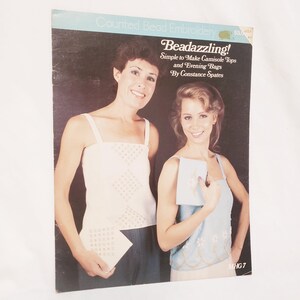May include: A vintage book cover titled "Beadazzling!" featuring two women wearing camisole tops. The cover has text that reads "Simple to Make Camisole Tops and Evening Bags By Constance Spates". The background is dark with a teal banner at the top.