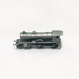 May include: A silver model train engine with the word "Yorkshire" on the side.