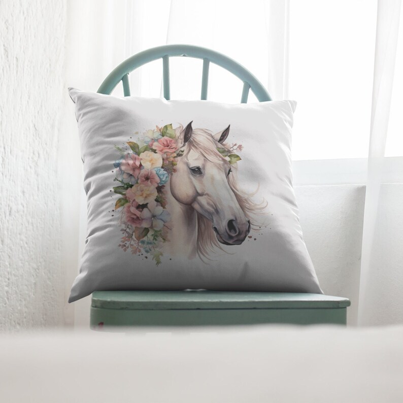 May include: White horse head with a floral crown of pink, yellow, and blue flowers. The horse is facing to the right and has a white background.