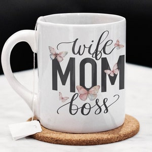 May include: White ceramic mug with a black design that says "wife mom boss" with butterflies around the text.