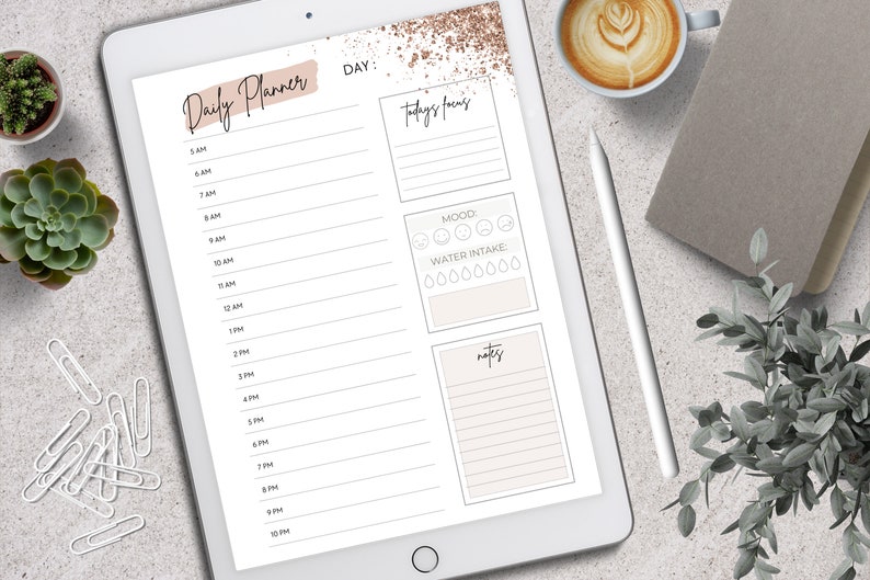 May include: A digital daily planner displayed on a tablet. The planner features sections for time slots, today's focus, mood, water intake, and notes. The design includes a neutral color palette with decorative accents and text that reads "Daily Planner".