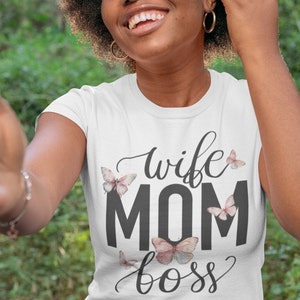May include: White t-shirt with the text "wife mom boss" in black lettering and pink butterfly graphics.