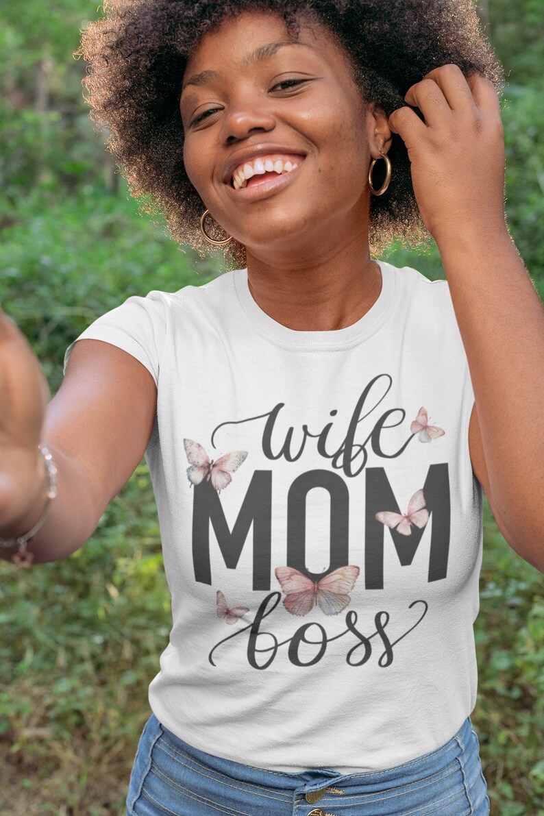 May include: White t-shirt with the text "wife mom boss" in black lettering and pink butterfly graphics.