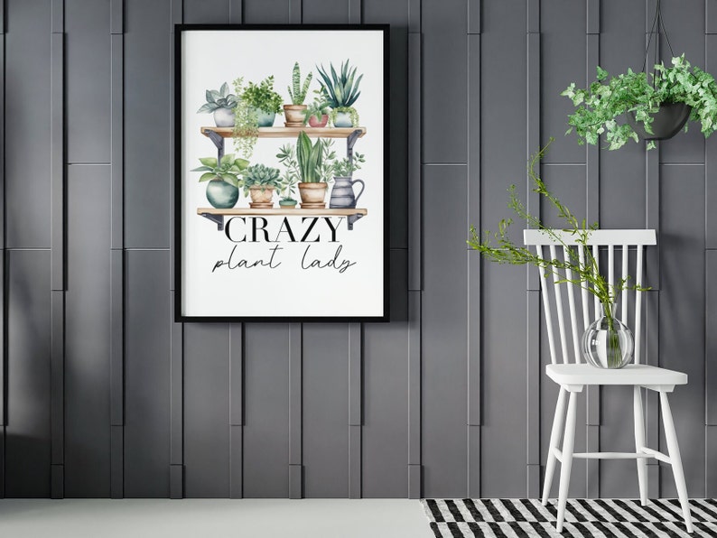 May include: A white background with a black frame around a watercolor illustration of a shelf with potted plants. The text "CRAZY plant lady" is below the shelf.