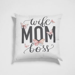 May include: White throw pillow with the text "wife mom boss" in black lettering and a decorative butterfly design.