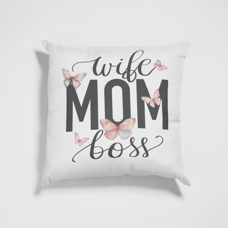 May include: White throw pillow with the text "wife mom boss" in black lettering and a decorative butterfly design.