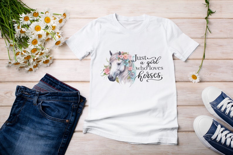 May include: White t-shirt with a watercolor illustration of a horse's head with flowers. The text "Just a girl who loves horses" is written in black cursive.