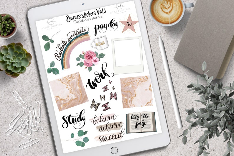 May include: A digital tablet displaying a collection of digital stickers with motivational phrases, floral elements, and butterfly graphics. The stickers include phrases like "Radiate Positivity," "Work," and "Believe, Achieve, Succeed."