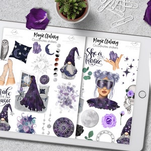 Puede incluir: Una tableta digital que muestra pegatinas "Magic Galaxy" de Goodnotes. Las pegatinas presentan ilustraciones celestiales y místicas en morado y blanco, incluyendo gnomos, lunas, estrellas y una mujer con maquillaje temático espacial. También se ve una taza de café y un lápiz óptico.