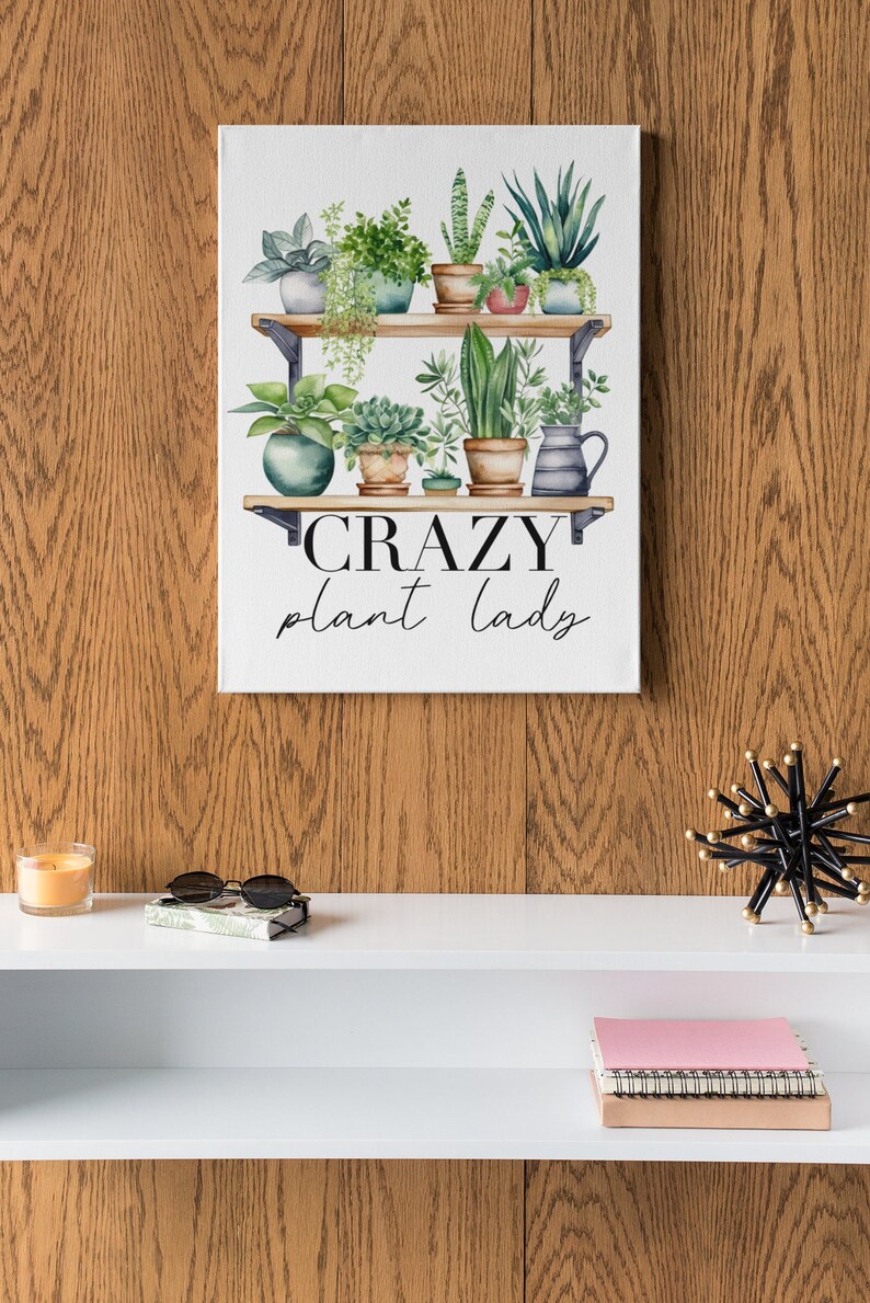 May include: A white canvas print with a watercolor illustration of a shelf with potted plants. The text "CRAZY plant lady" is written below the shelf.