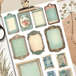 May include: A sheet of vintage-style decorative paper with various frames, borders, and stamps. The paper features a light blue and cream color scheme with intricate details.
