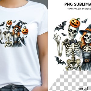 May include: White t-shirt featuring a Halloween-themed design. The graphic depicts two skeletons, one wearing a pumpkin on its head and the other a witch hat, holding a jack-o'-lantern. Bats are scattered around the skeletons.