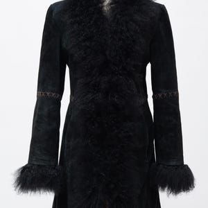 May include: A black suede coat with a faux fur collar and cuffs. The coat features a tailored silhouette with decorative stitching on the sleeves and a flared hem. The fur trim adds a touch of luxury to this outerwear piece.
