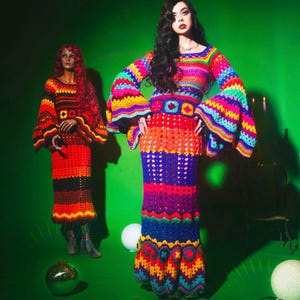 May include: Two crochet dresses in vibrant colors, displayed on a mannequin and a person. The dresses feature a rainbow of hues, with bell sleeves and a fitted silhouette. The background is a solid green.